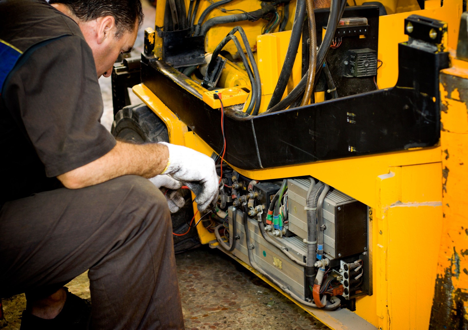 Mechanic working on a yellow machine
